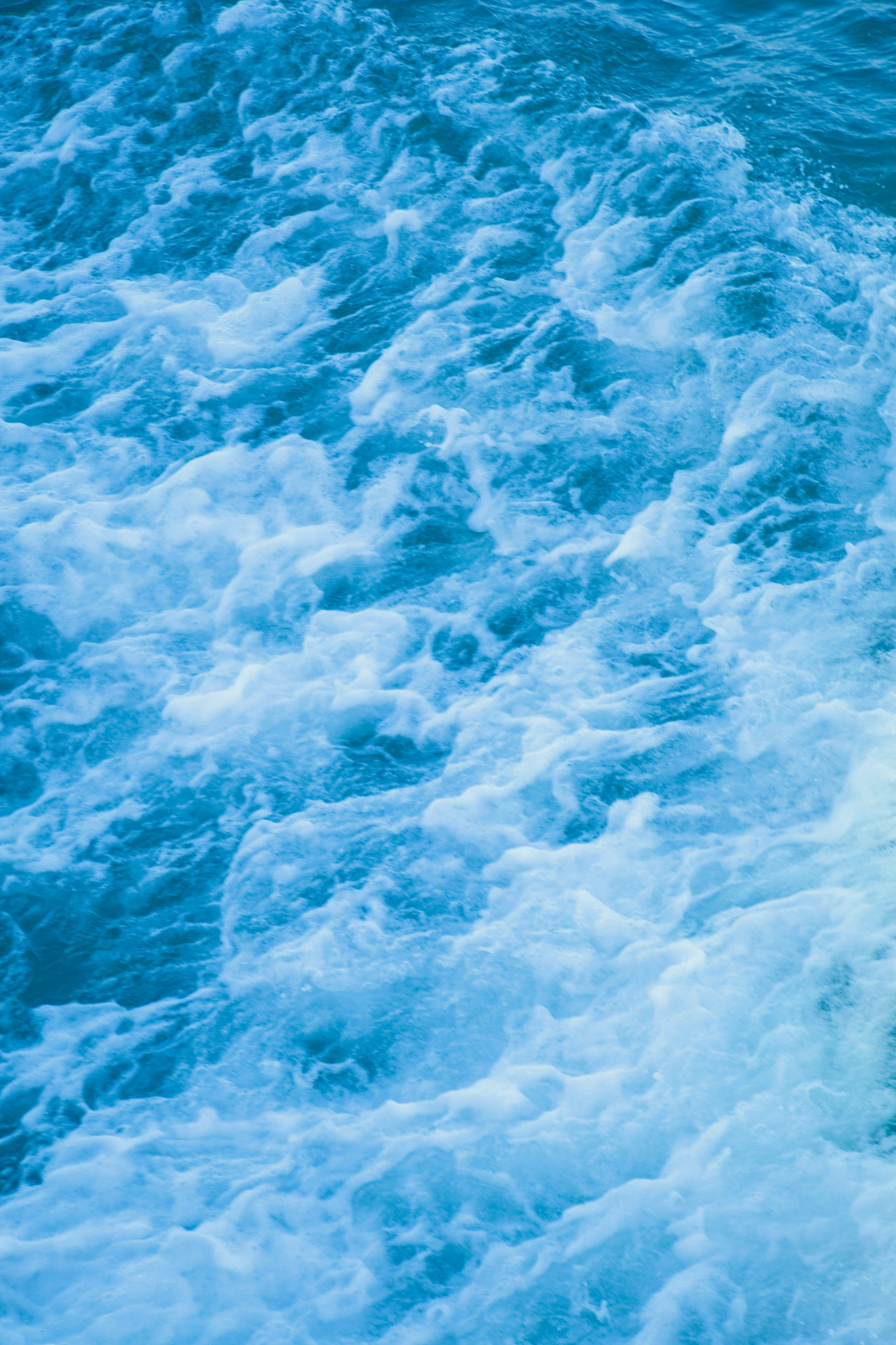 a man standing on top of a wave in the ocean