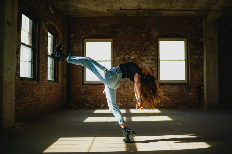 a woman in white shirt doing a skateboard trick