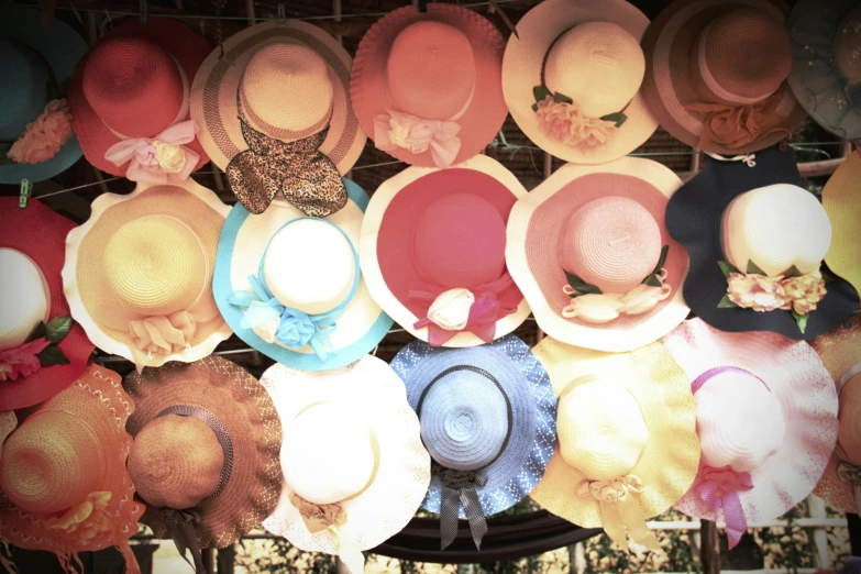 a wall covered with hats of all kinds and colors