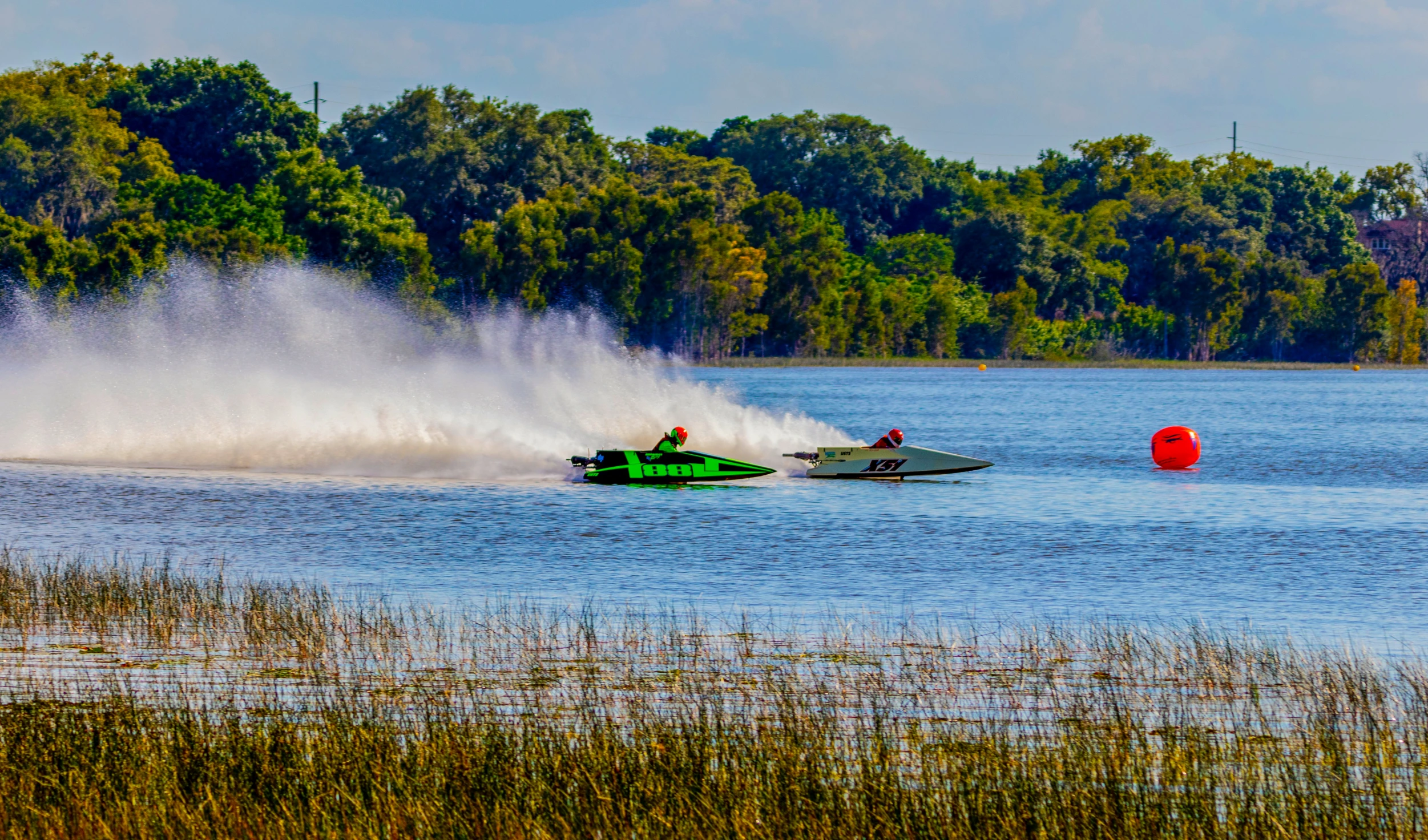 two people are being pulled by a jet boat on the water