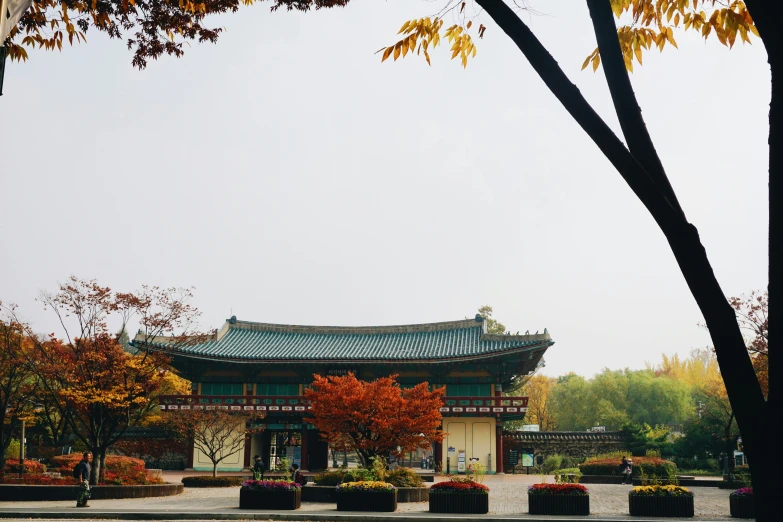 a pagoda on a small garden area under a cloudy sky