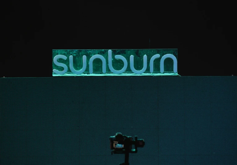 the word sunburn is displayed on the large screen