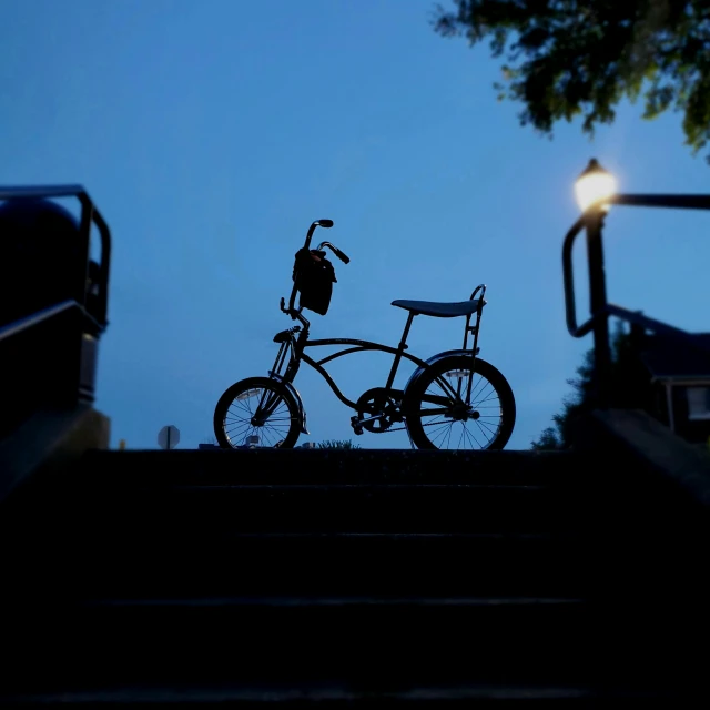 a bicycle sits on the edge of stairs