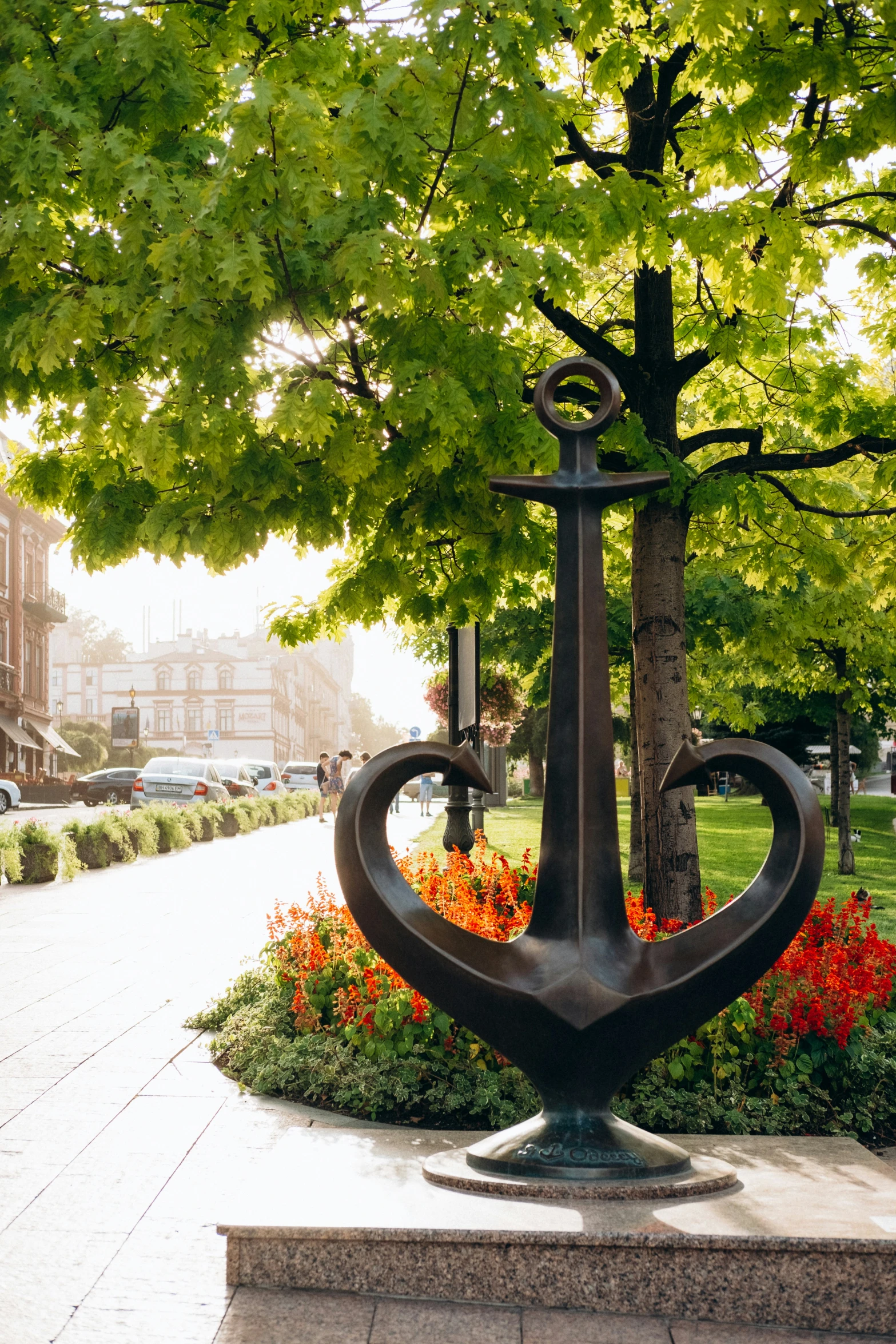 a garden with a metal flower pot and lamp