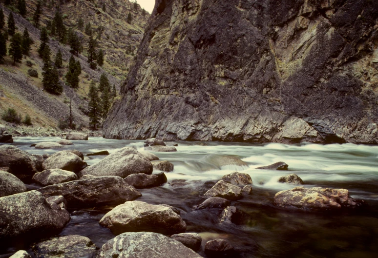 a stream flows near a large rock mountain