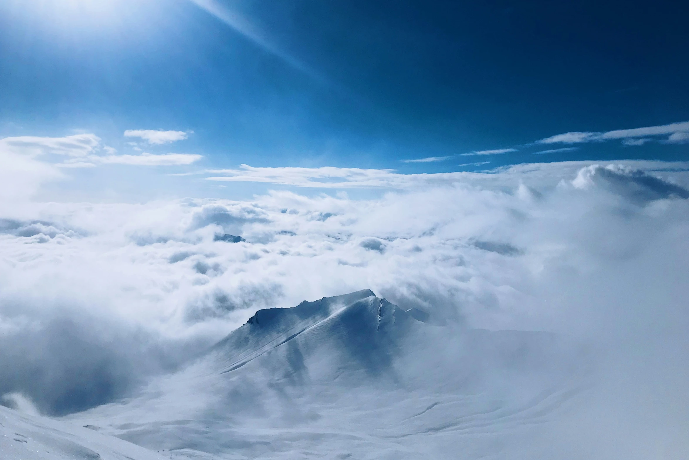 a po taken from an airplane window looking out at a mountain