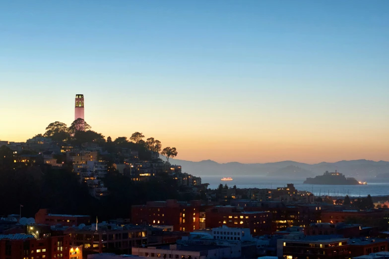 a city view at night with buildings and hills