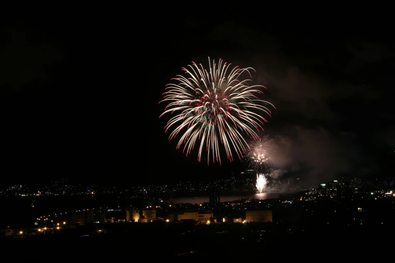 a large colorful fireworks over a city at night