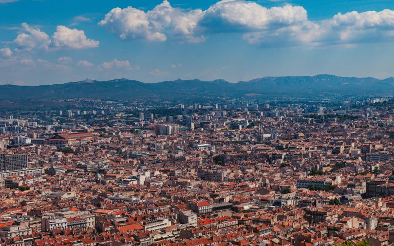 an aerial s of a city, with mountains in the background