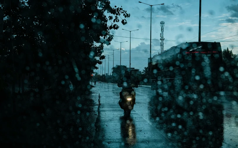 a man riding a bike in the rain