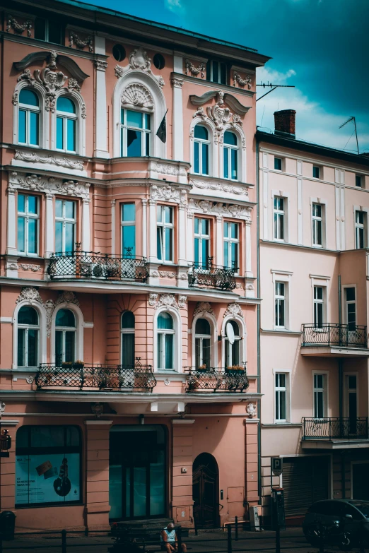 the building is pink and white and has two stories