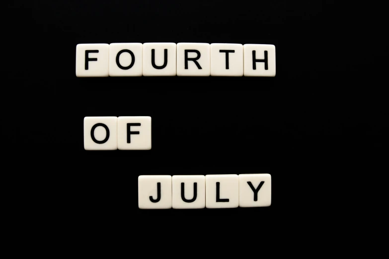 four small blocks that spell out the words fourth of july