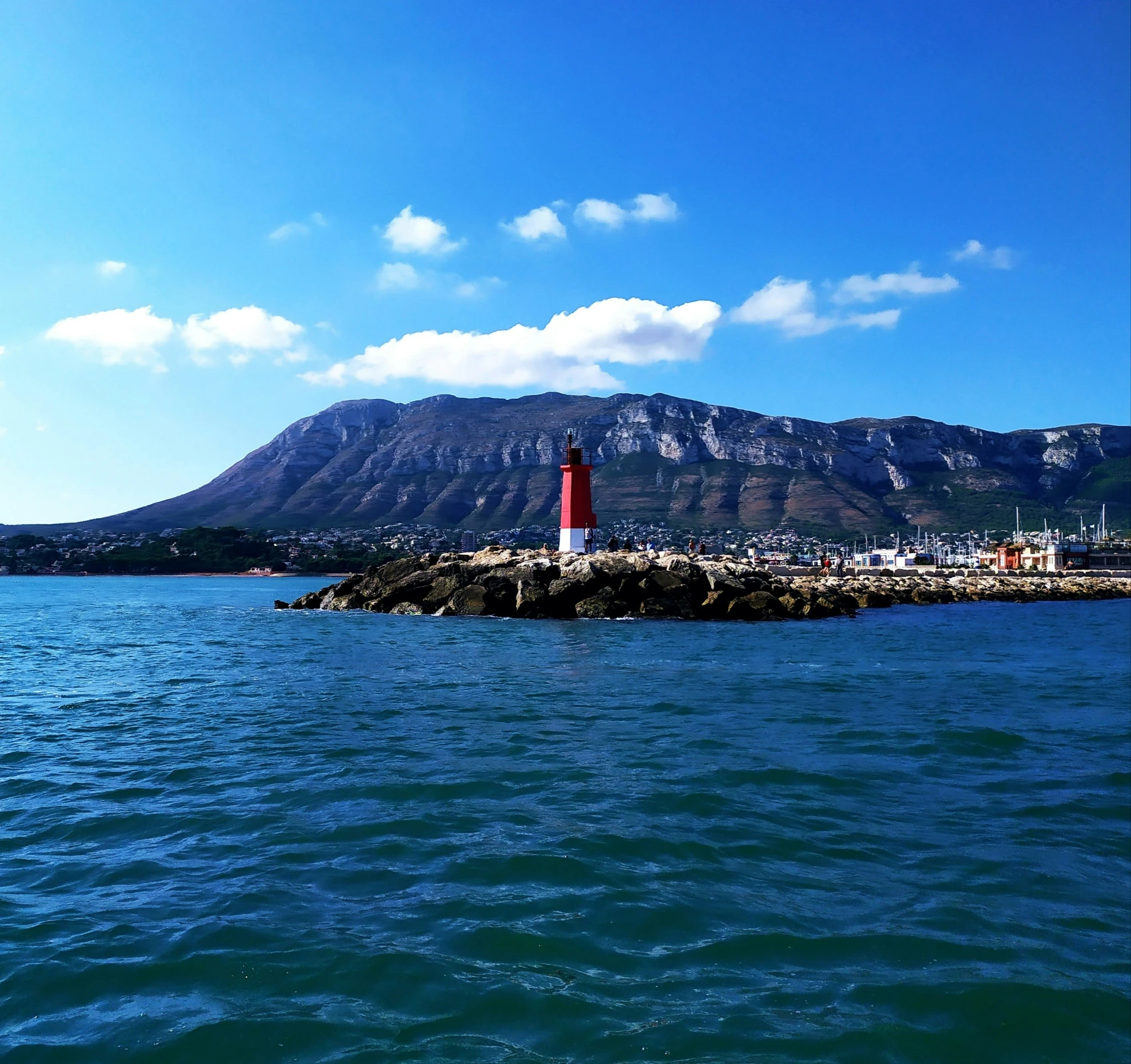 a lighthouse on the shoreline near a large body of water