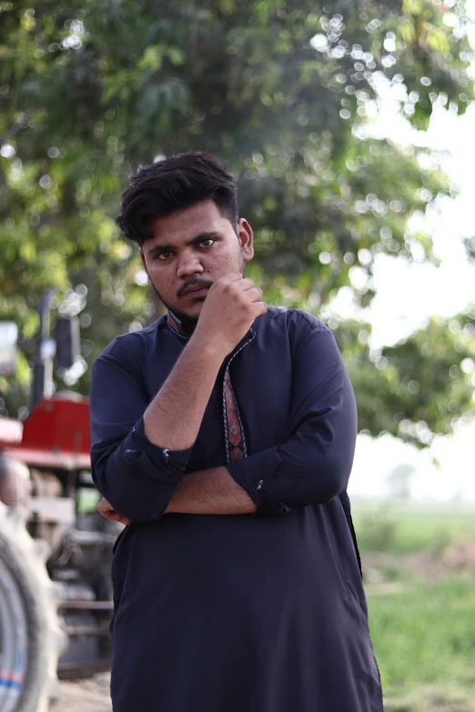 a man looks to the side as he talks on a phone