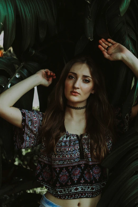 a girl wearing a necklace, wearing a flowery crop top