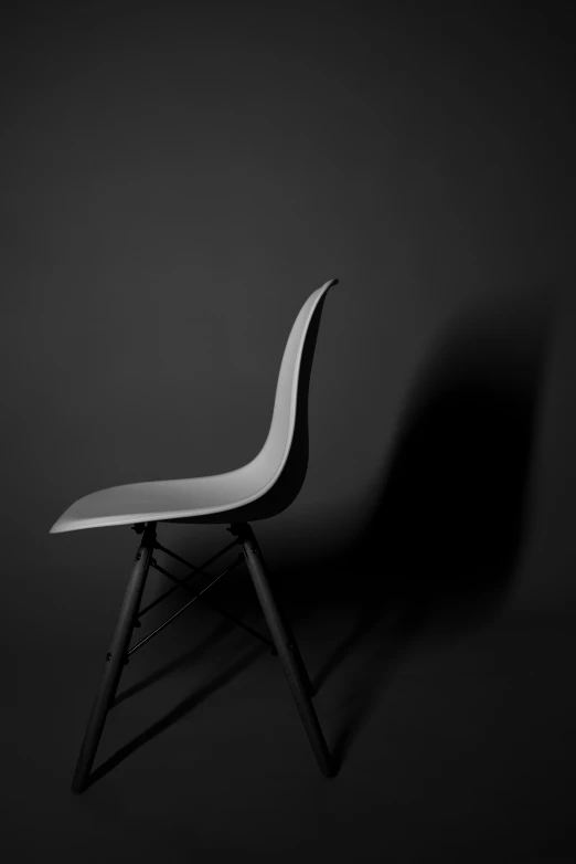 a chair sitting on top of a dark background
