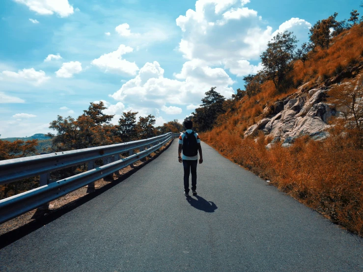 a man walking down the road on one foot and the other hand