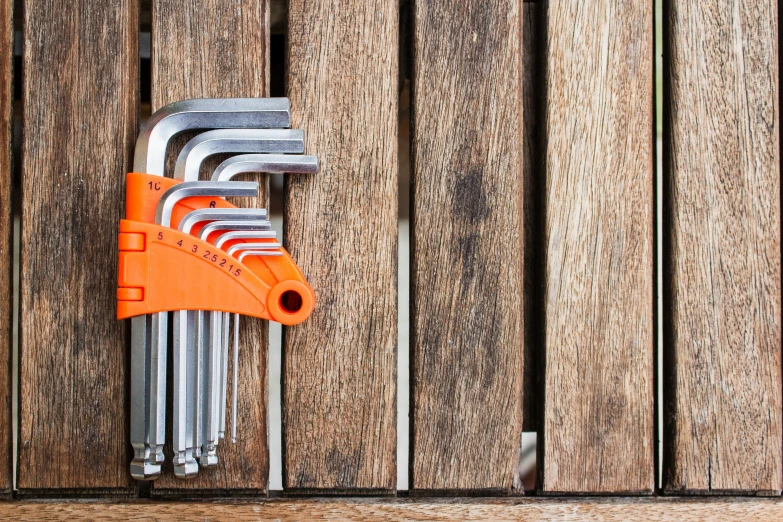 a bunch of keys on a wall with a bottle opener