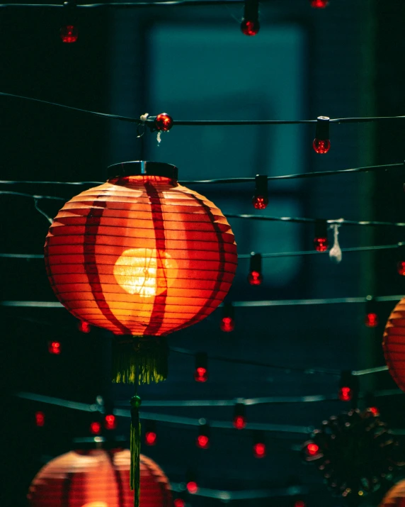 many lanterns are hanging outside near lights