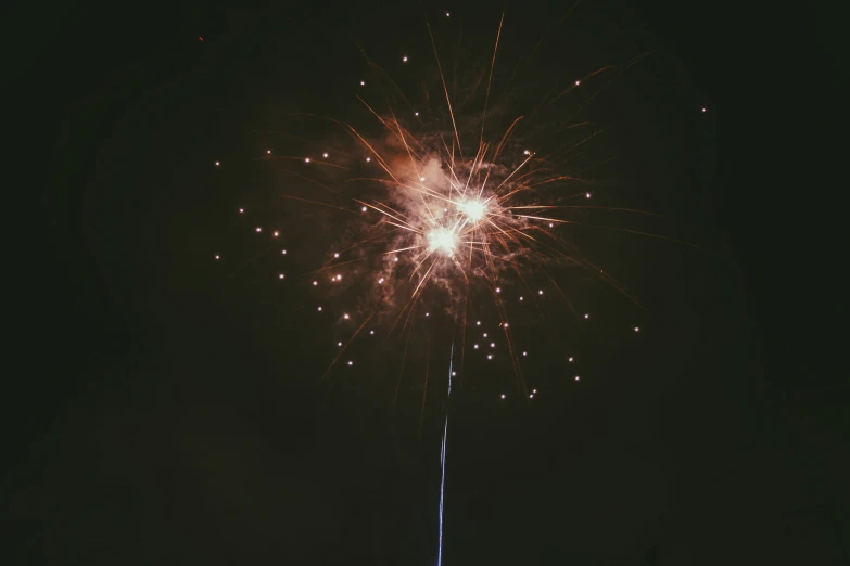 a brightly lit fireworks on top of a tall tower