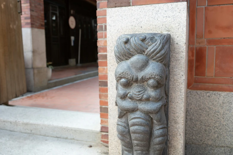 statue on side of building with large doorway