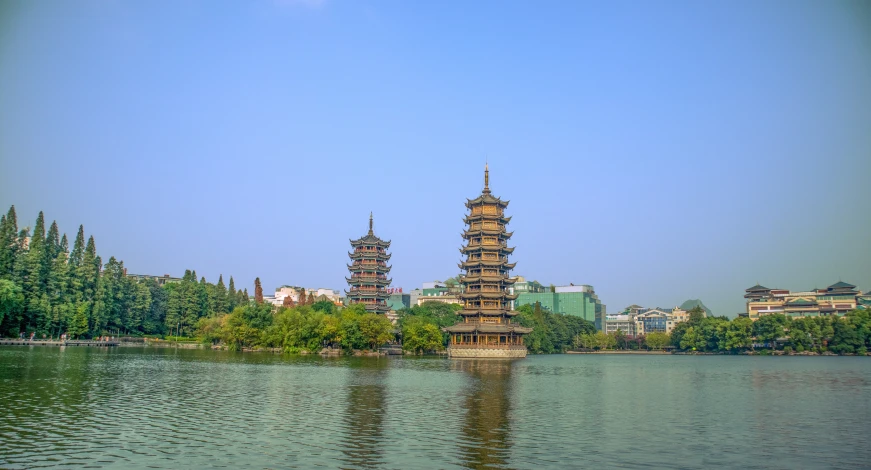 a building is shown from across a lake