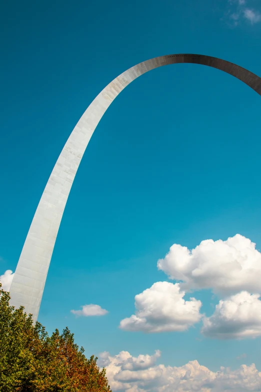 the arch is tall with trees below