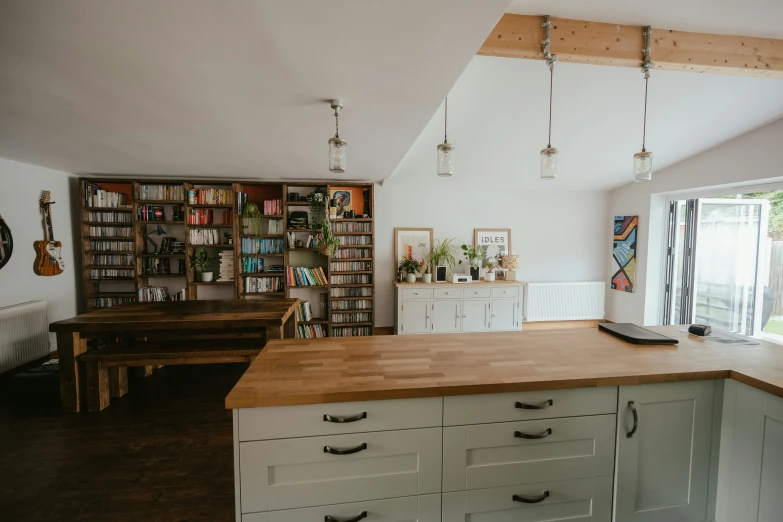 the view from an open kitchen area shows a dining room and living room