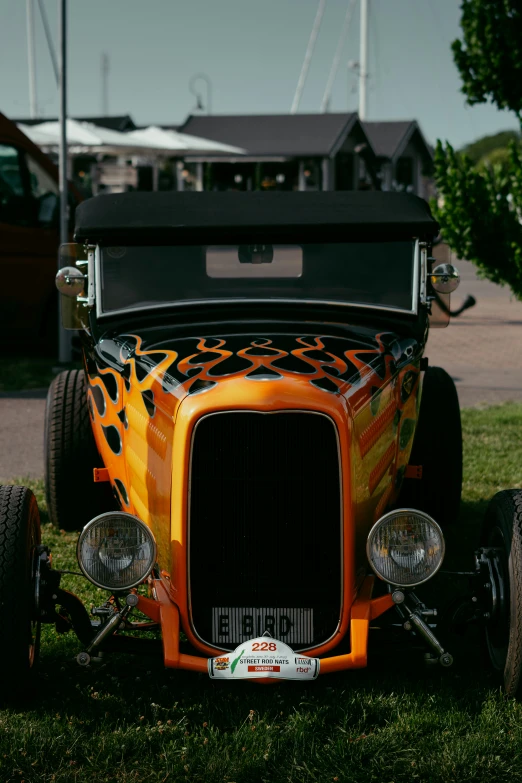 an old truck sits parked in the grass