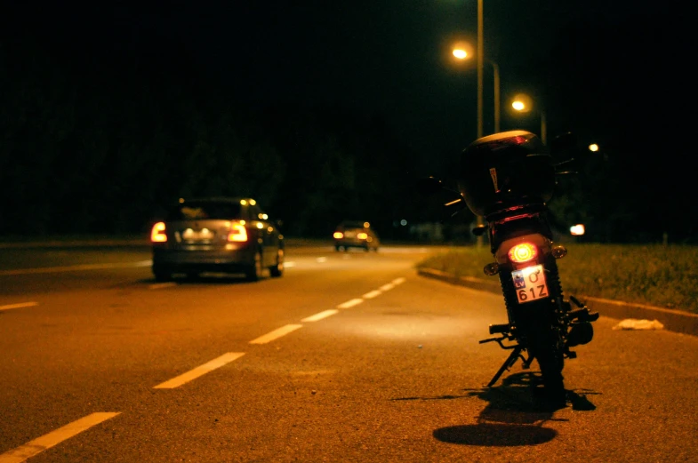 a red motorcycle is parked on the side of the road
