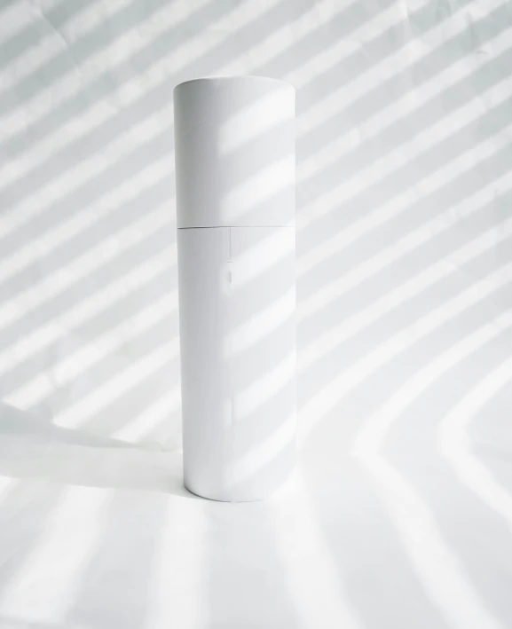 a tall white tube on a white surface