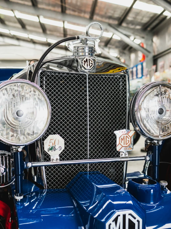 a number of antique cars are being worked on