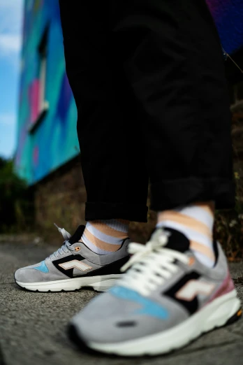 a man is wearing colorful socks and sneakers