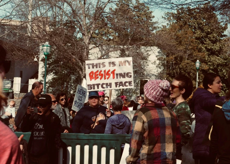 a group of people gathered outside of a building for protest