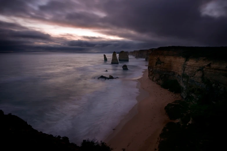 the coast line has tall rock formations in it