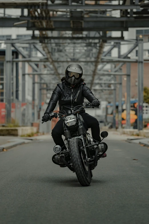 man riding his motorcycle down the road in the city