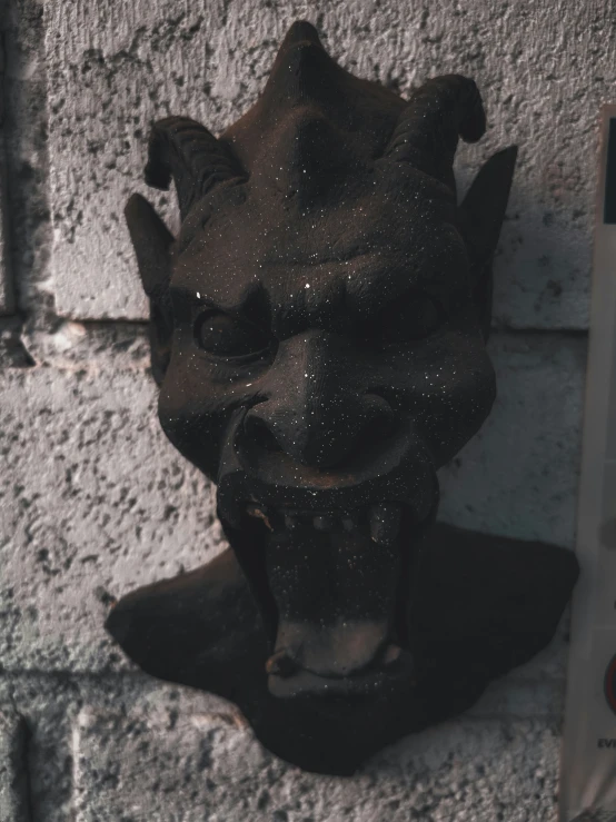 a close up of a black statue of a lion's head