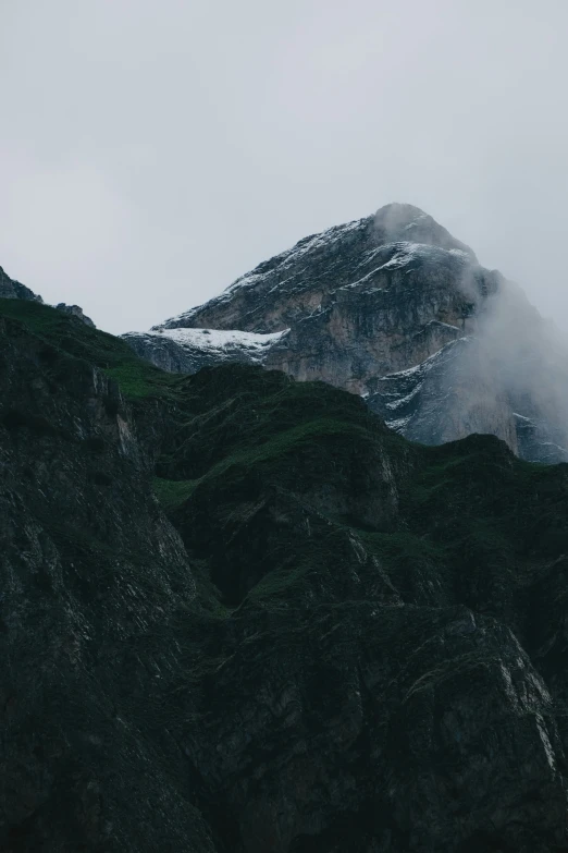 clouds hanging over the mountains and fog lifting in