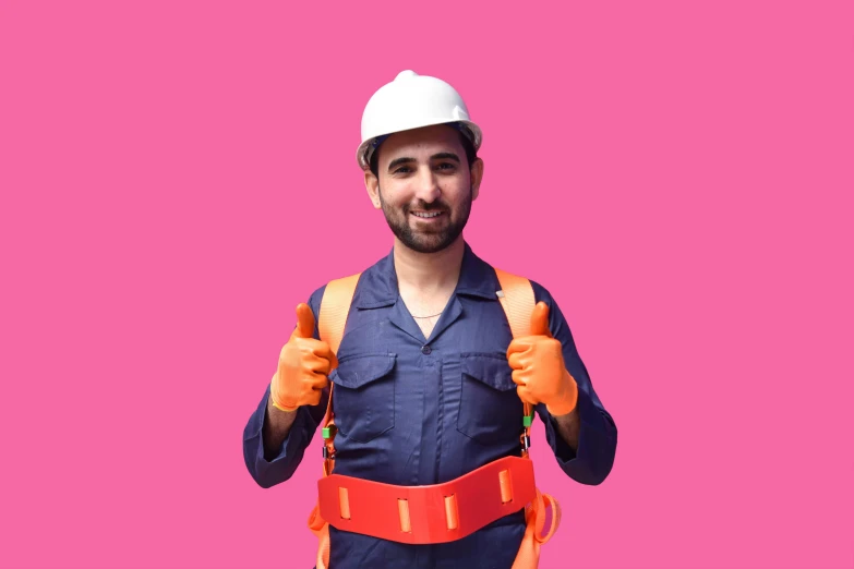 a person in workwear holding up two thumbs