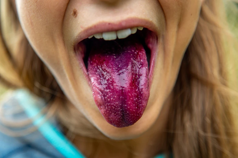 a girl sticks her tongue out to lick it