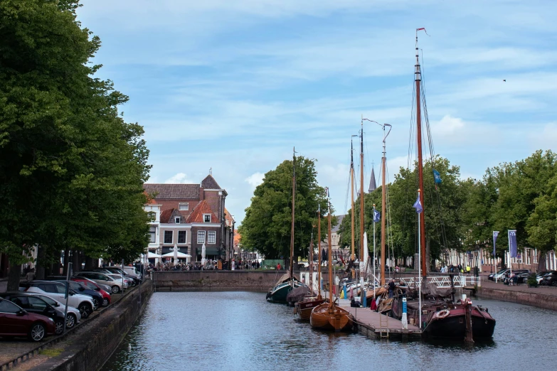 several boats moored along a waterway in a town