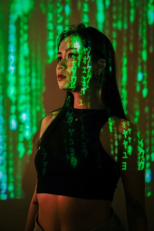 a woman standing in front of a green light