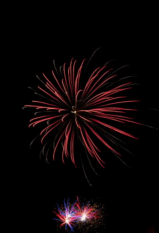 fireworks is lit on the dark night sky