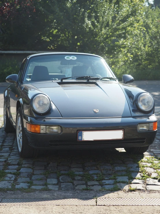 a grey sports car parked on the side of the road