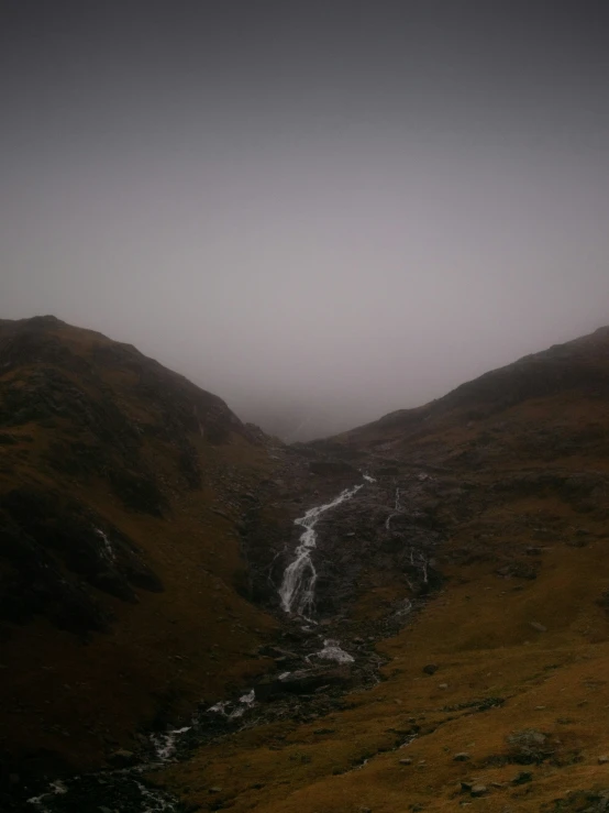 the hills are covered in thick fog and fog