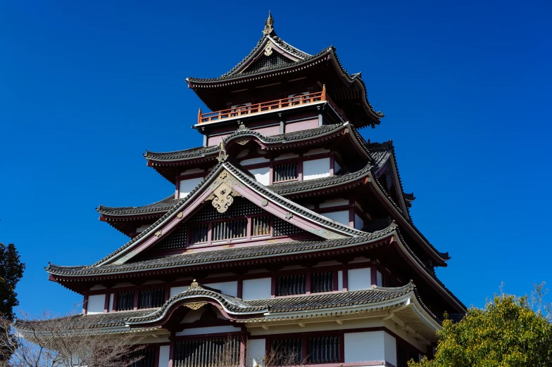 an asian style building with a clock on the top