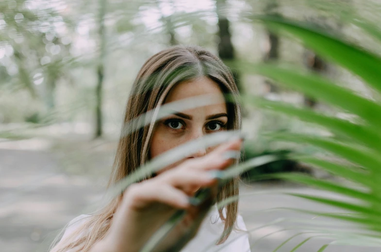girl with blurry hair standing in the forest