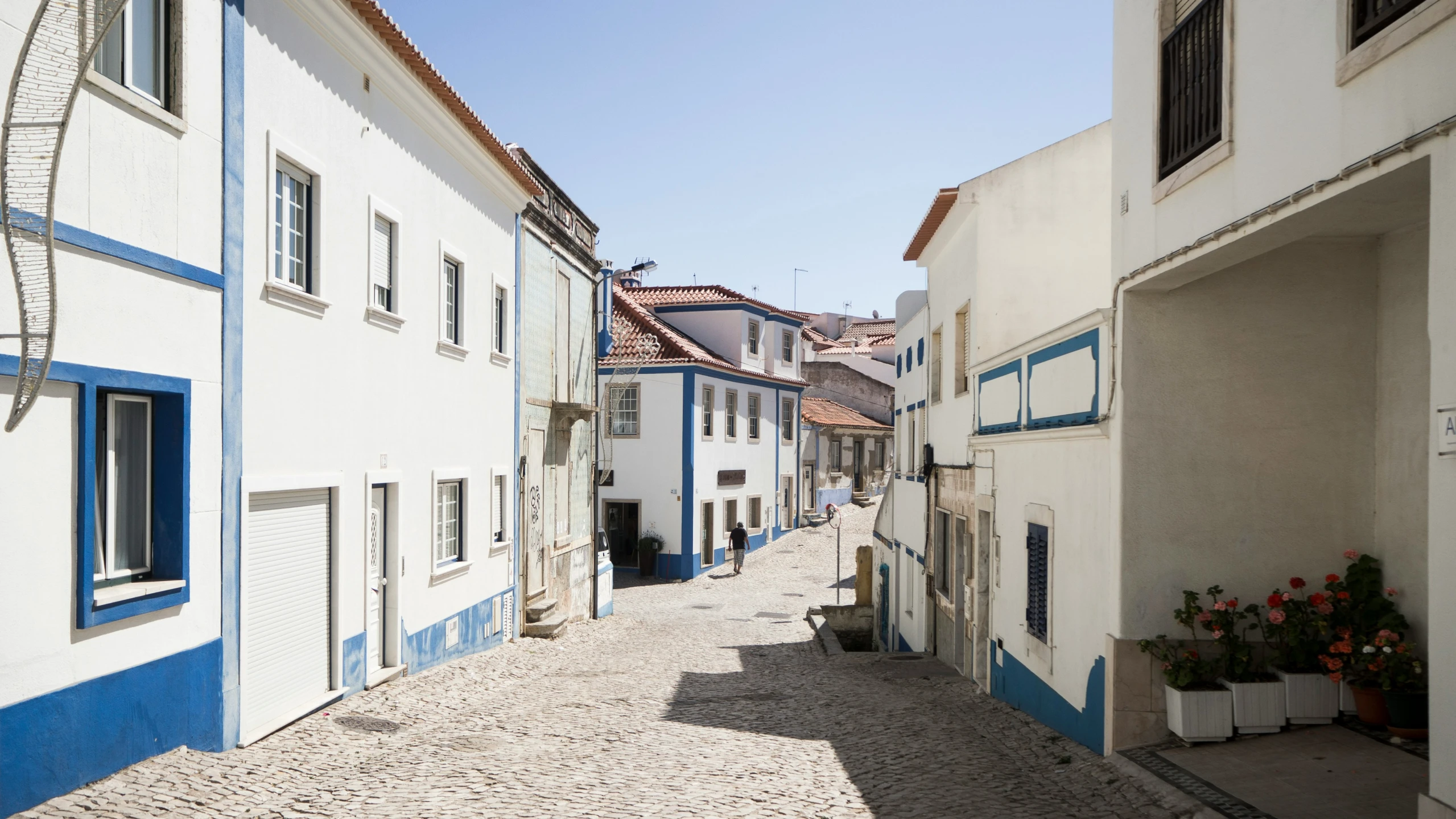 a narrow street that leads to several buildings