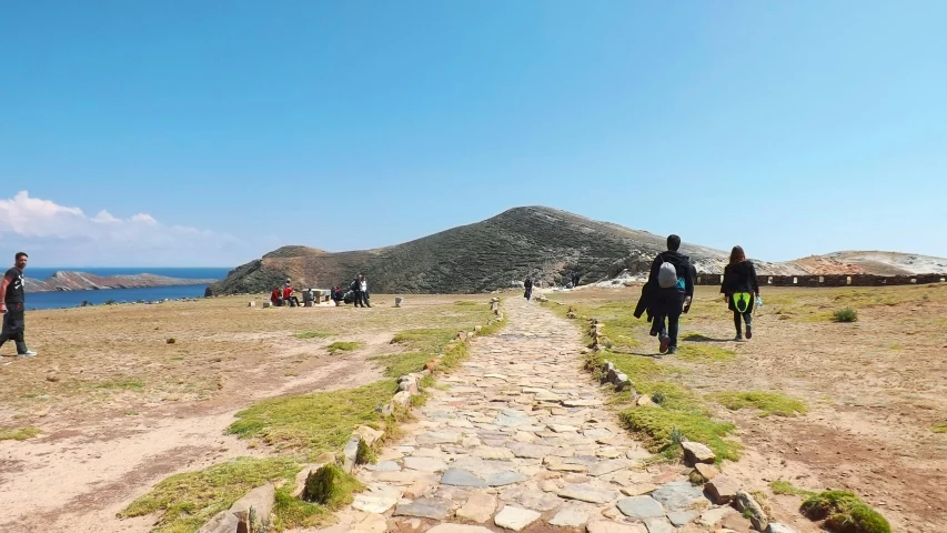 a group of people walking up and down a hill