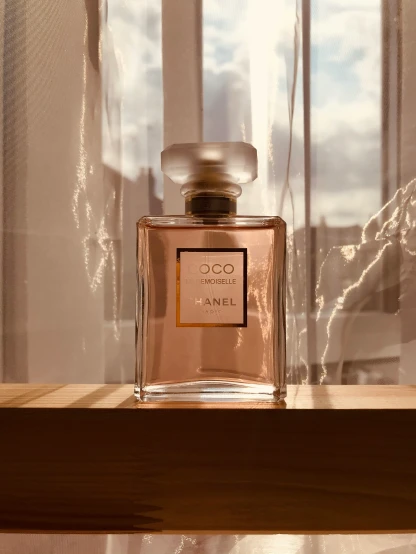 a bottle of perfume on a wooden shelf
